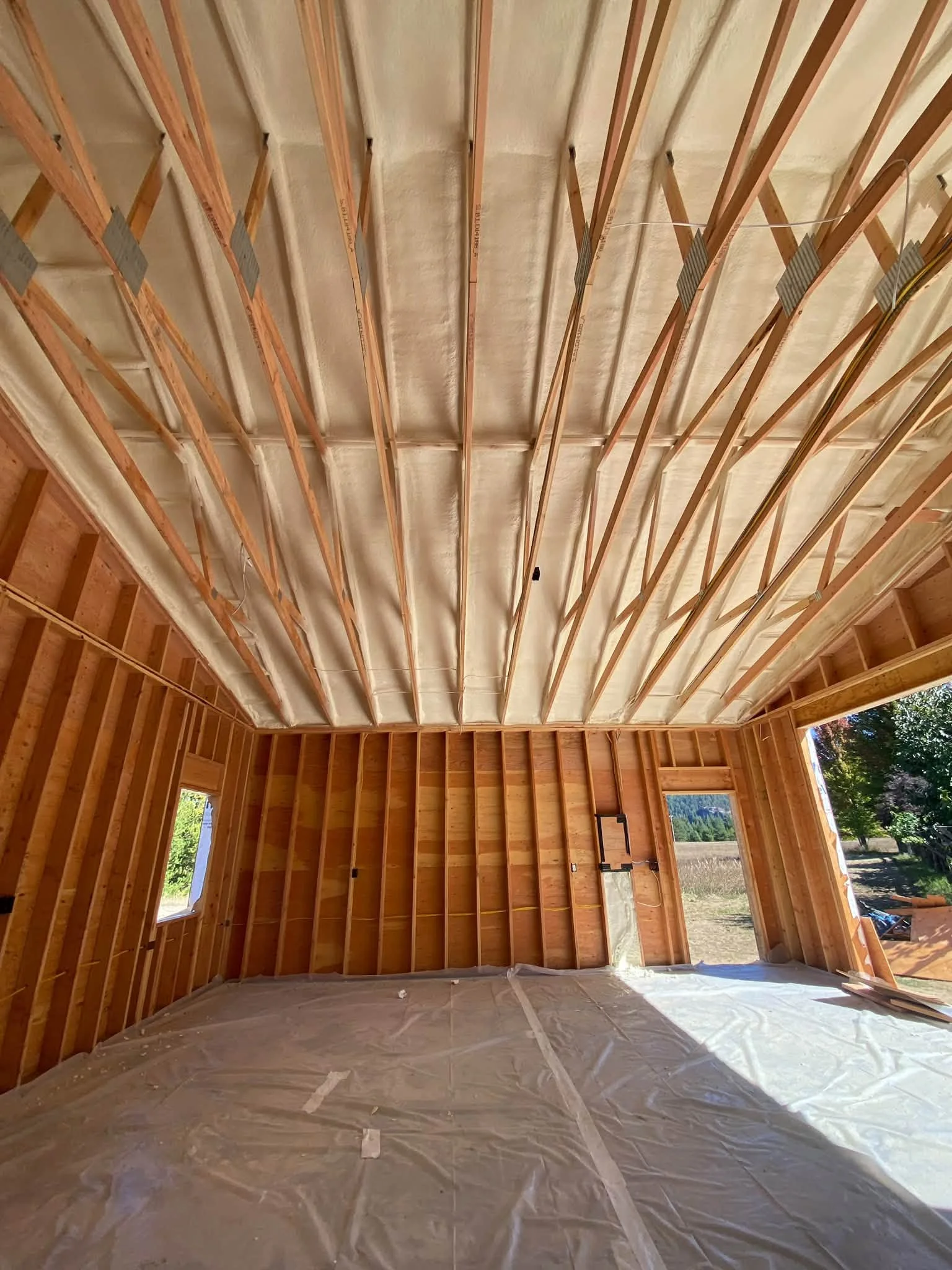 How Does Roof Design Influence Spray Foam Insulation Requirements in Dover, ID?
